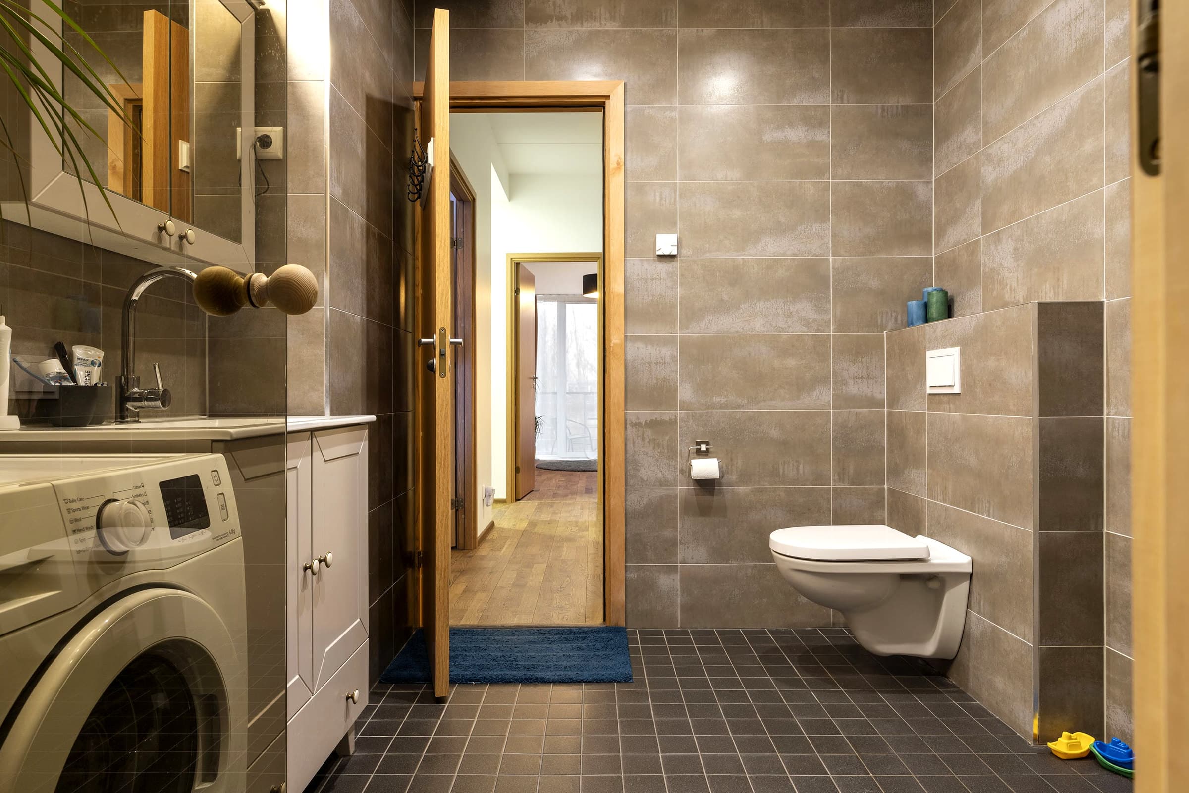 Finished bathroom with utility area.